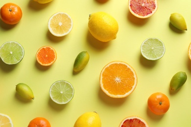 Different citrus fruits on color background, flat lay