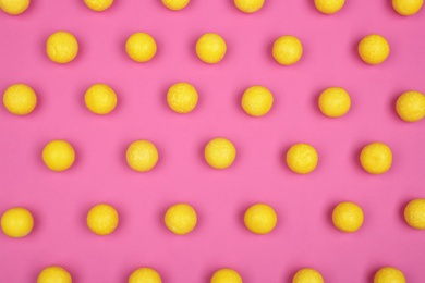 Photo of Many delicious lemon drops on pink background, flat lay