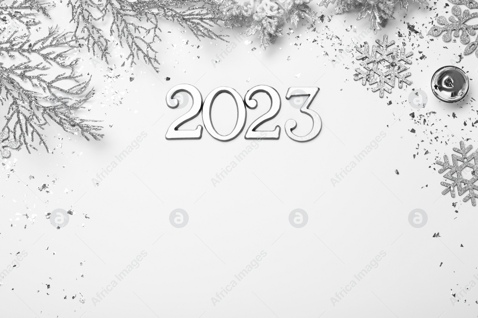 Photo of Flat lay composition with number 2023 and festive decor on white background, space for text. Happy New Year