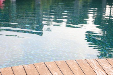 Photo of Outdoor swimming pool with wooden deck at resort