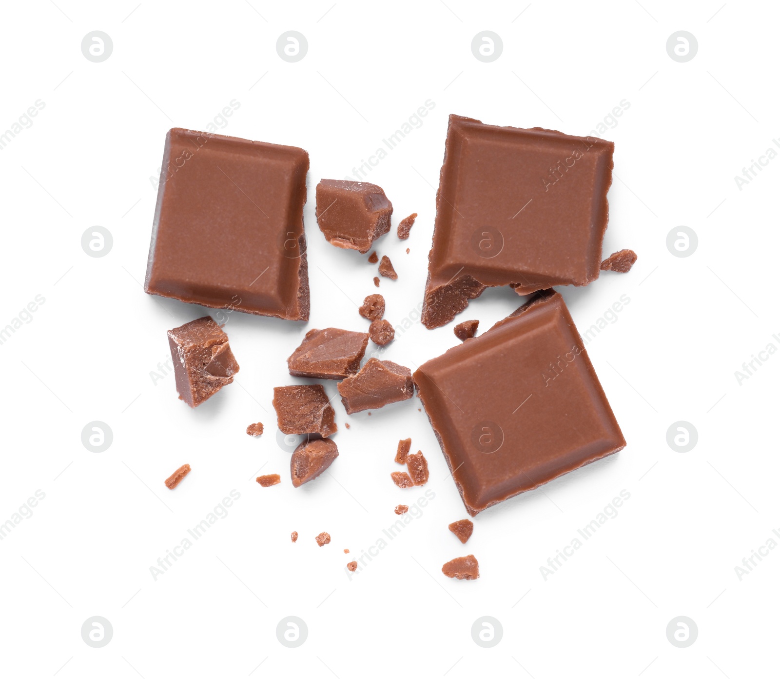 Photo of Pieces of delicious milk chocolate bar on white background, top view