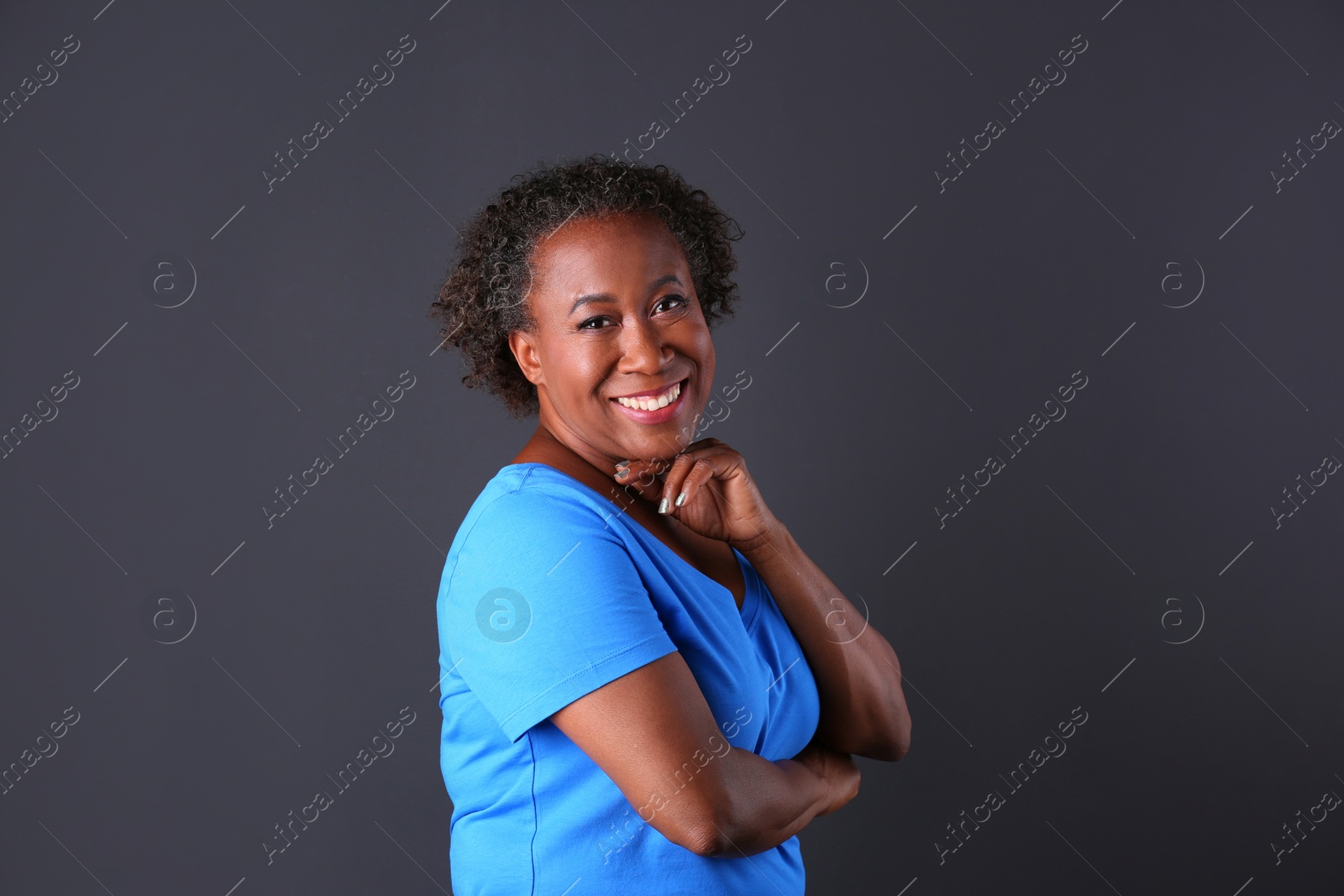 Photo of Portrait of happy African-American woman on black background