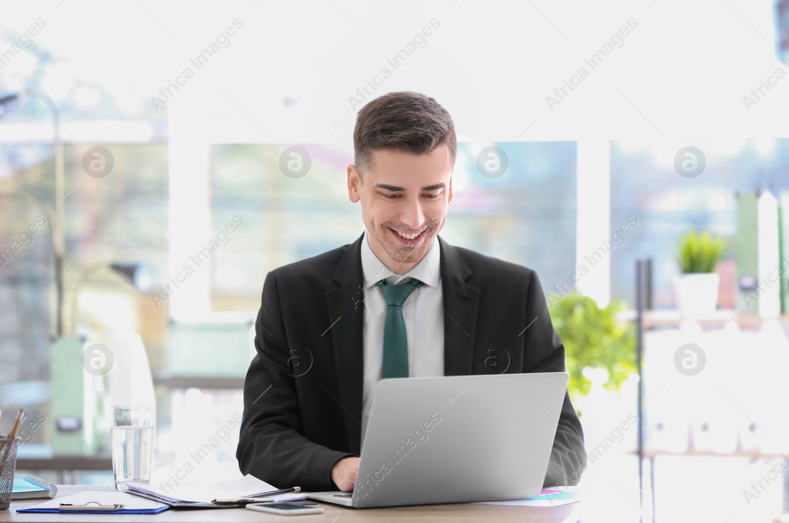 Photo of Consultant working at table in office