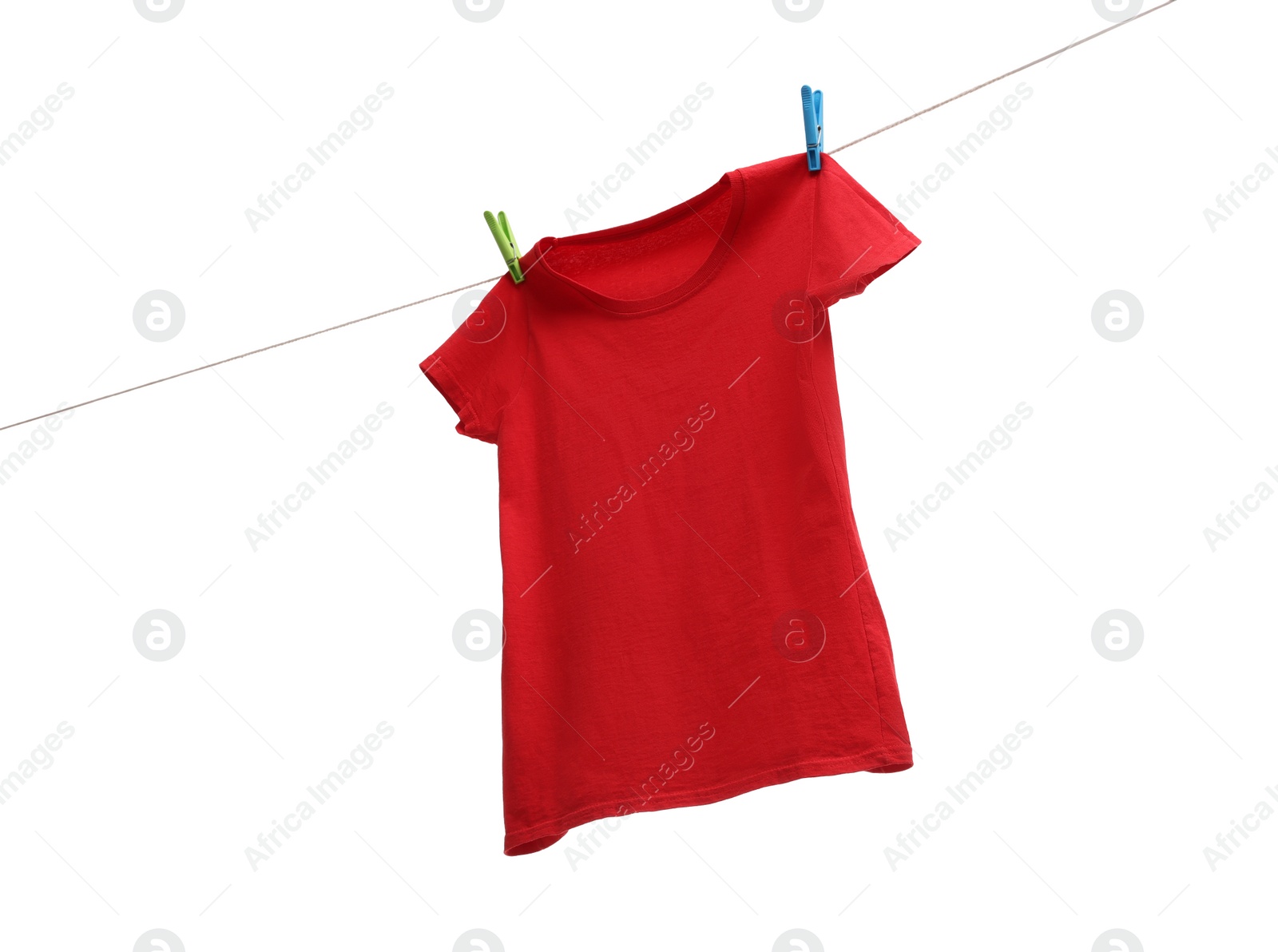 Photo of One red t-shirt drying on washing line isolated on white