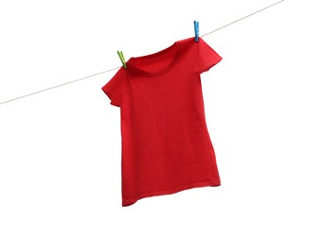 One red t-shirt drying on washing line isolated on white