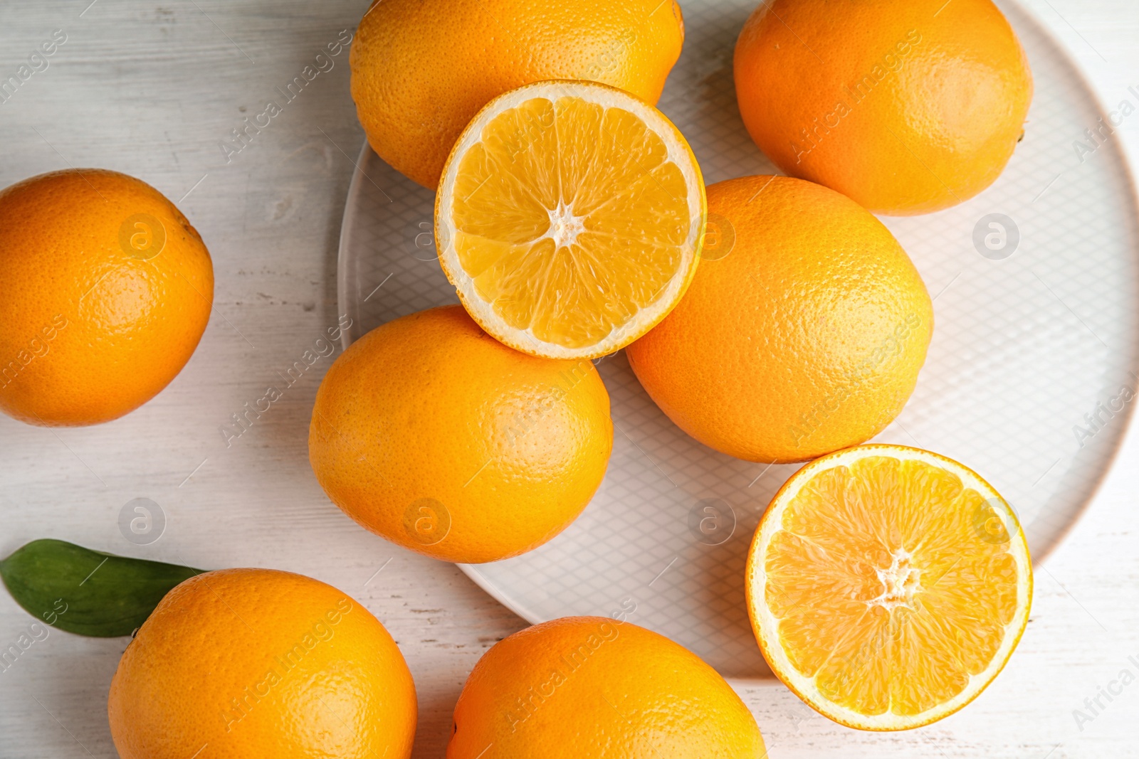 Photo of Flat lay composition with fresh oranges on wooden table