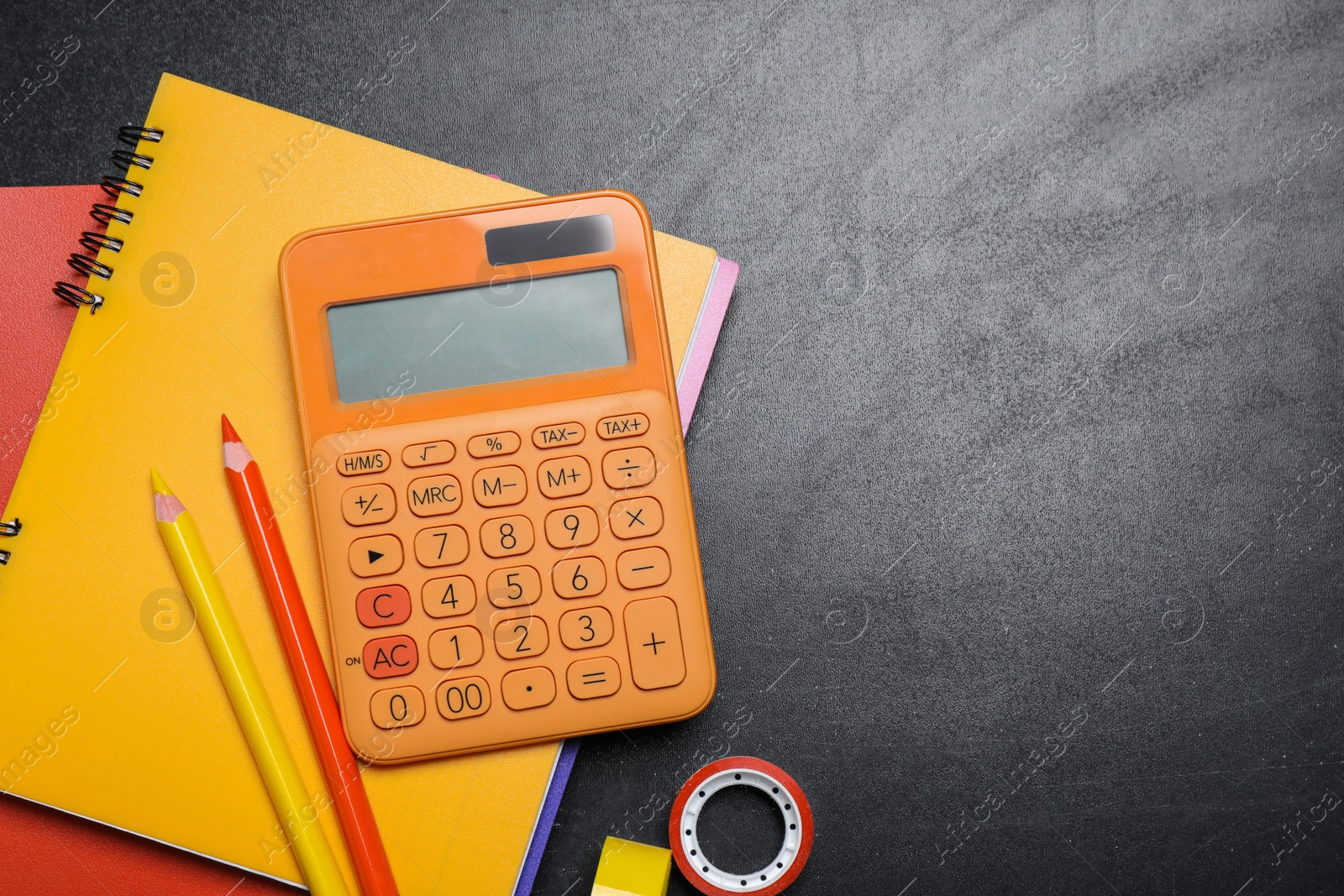 Photo of Flat lay composition with school stationery on blackboard, space for text