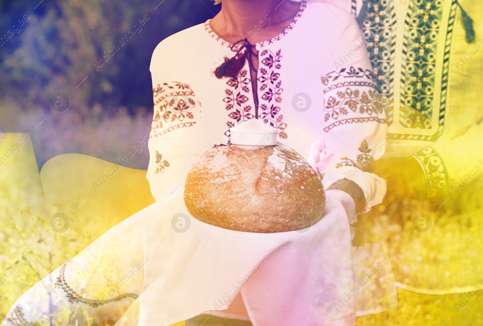 Image of Double exposure of Ukrainian flag and mature couple wearing national clothes with bread and salt outdoors, closeup