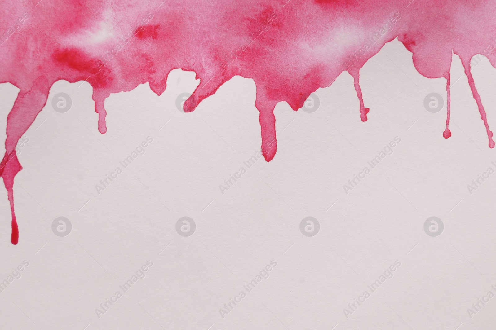 Photo of Magenta watercolor blots on white canvas, top view. Space for text