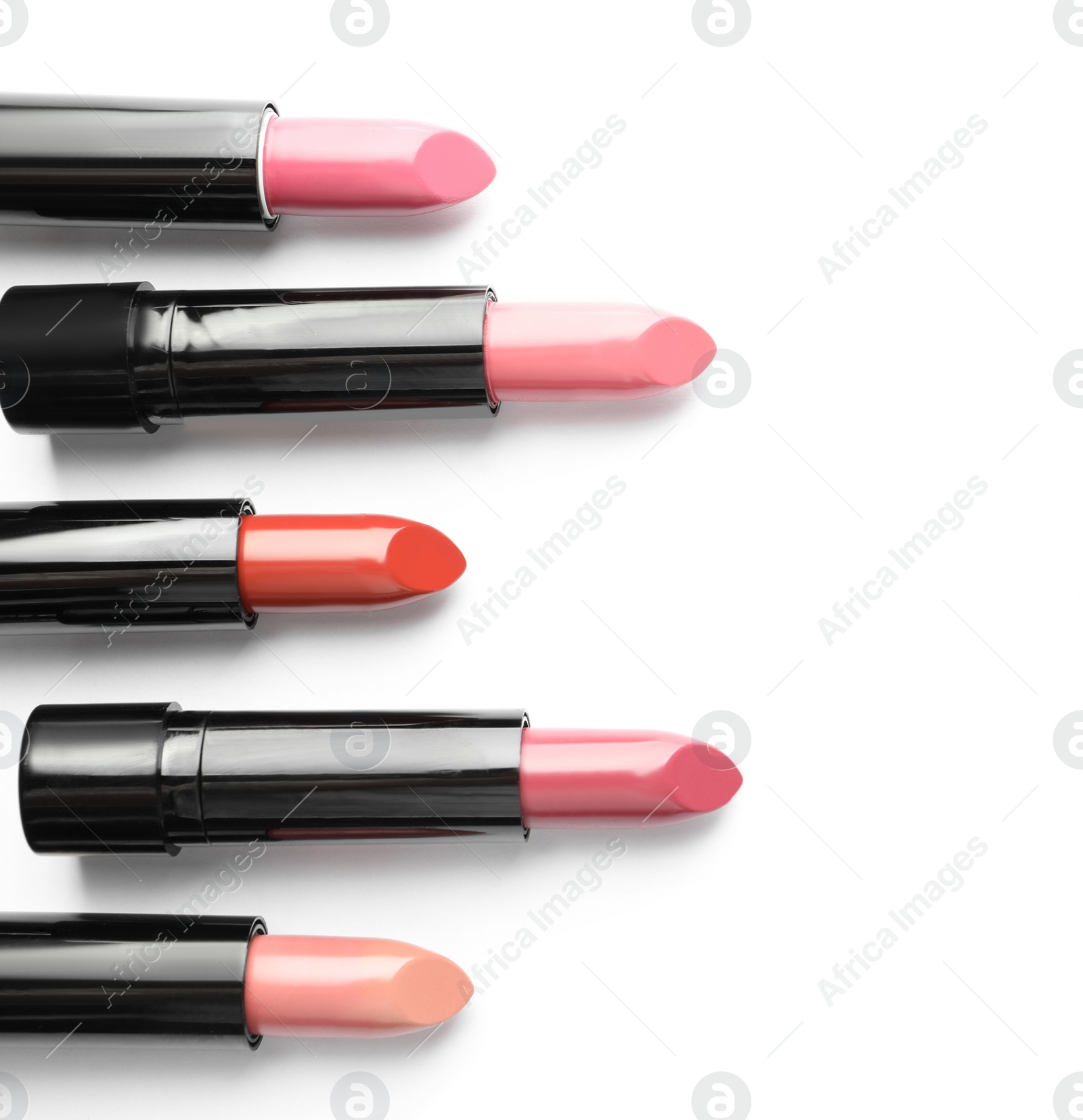 Photo of Different lipsticks on white background, top view