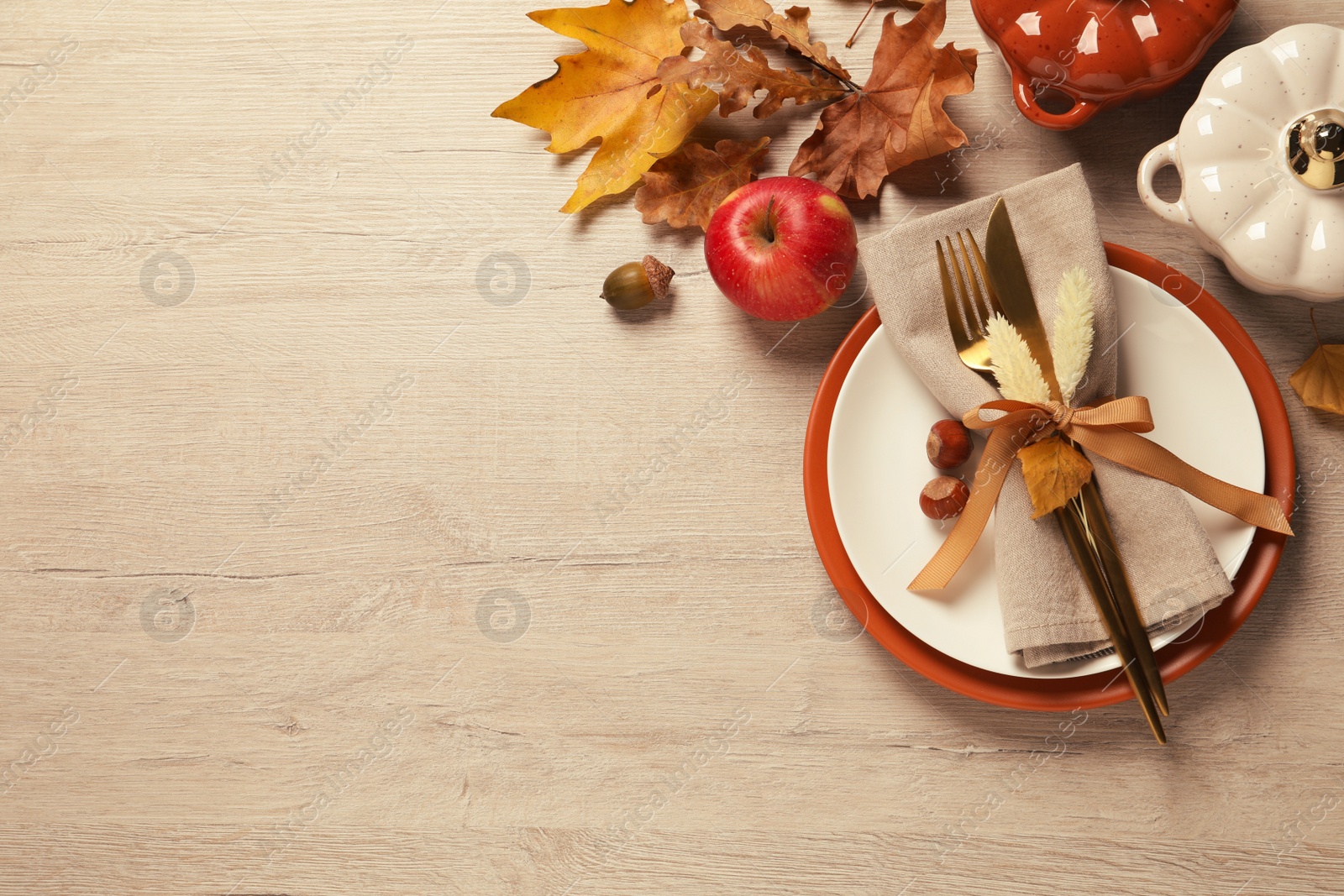 Photo of Autumn table setting on wooden background, flat lay. Space for text