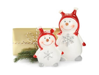 Christmas composition with decorative snowmen and gift box on white background