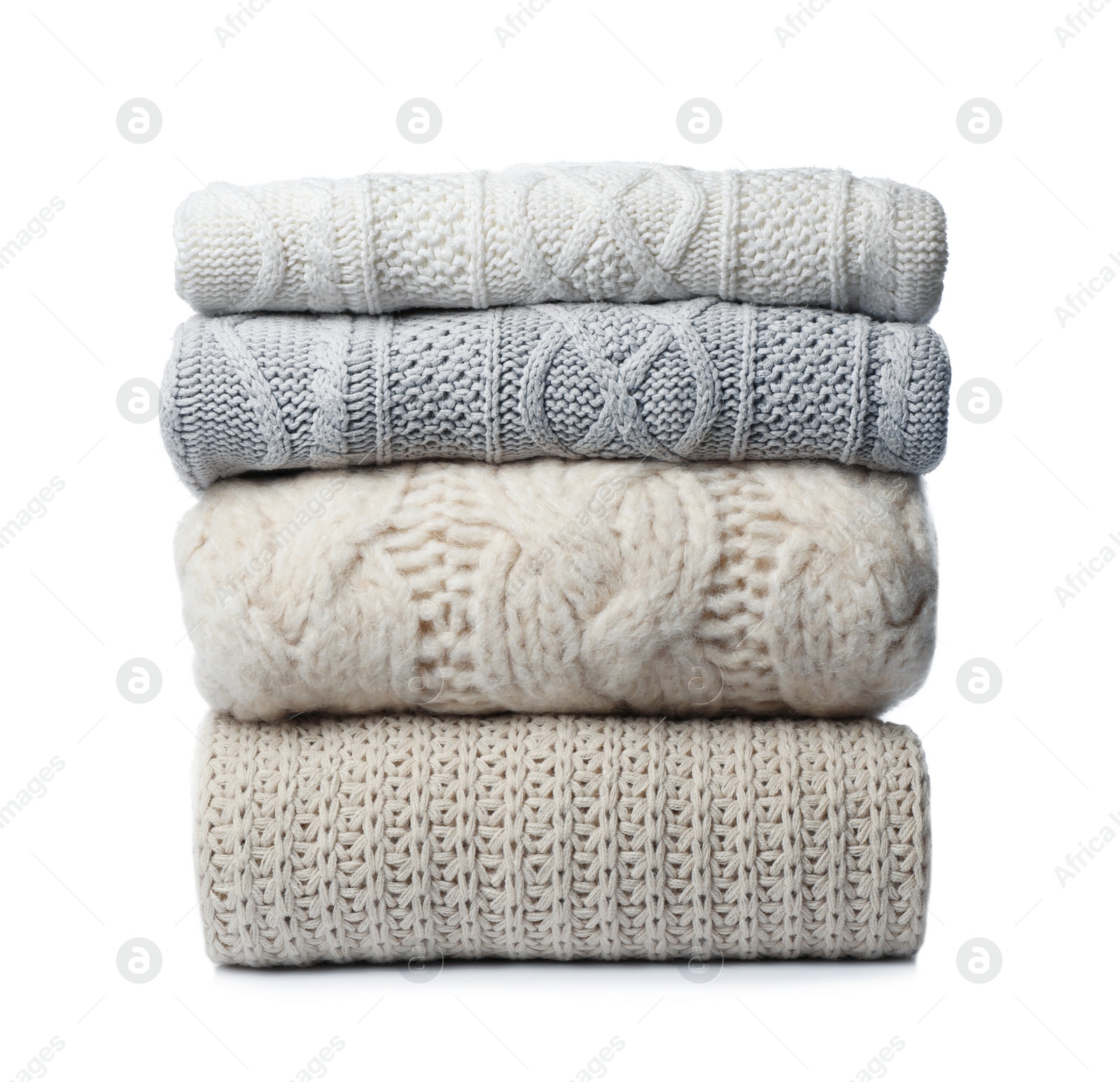 Photo of Stack of folded knitted sweaters on white background