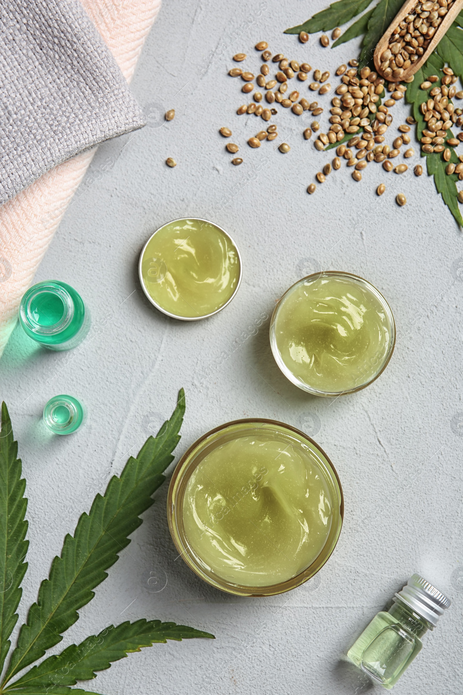 Photo of Flat lay composition with hemp lotion on grey background