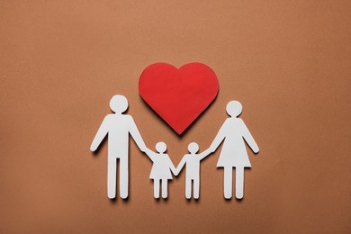 Photo of Paper family figures and red heart on brown background, flat lay. Insurance concept