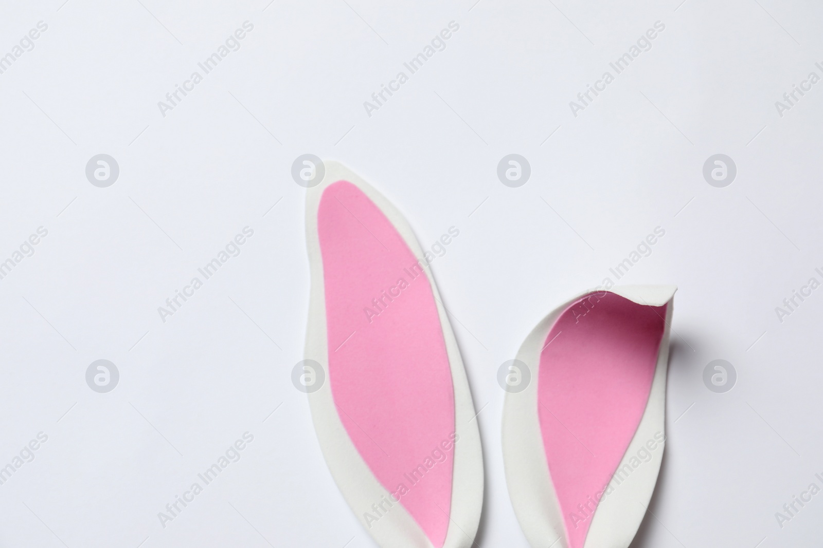 Photo of Funny Easter bunny ears on white background, top view