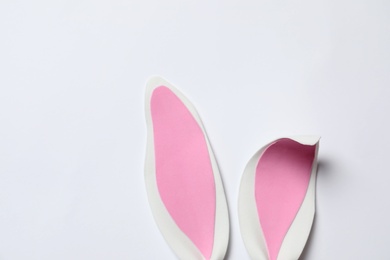 Photo of Funny Easter bunny ears on white background, top view