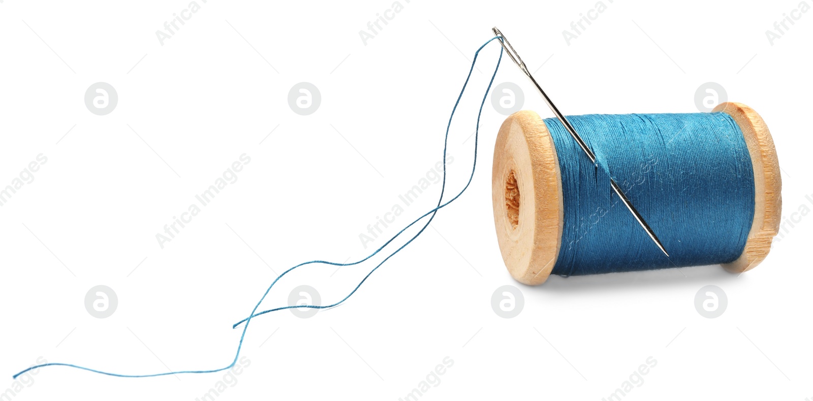 Photo of Light blue sewing thread with needle on white background