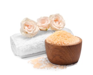 Photo of Orange sea salt in bowl, towel and flowers isolated on white