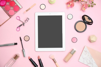 Flat lay composition with tablet and makeup products for woman on color background