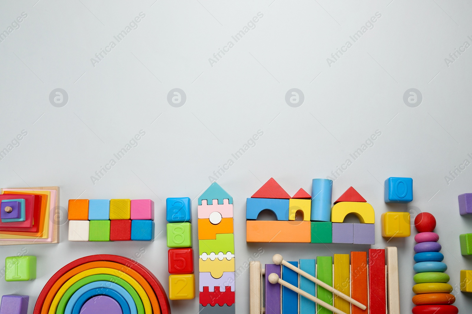 Photo of Different children's toys on light grey background, flat lay. Space for text