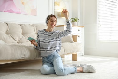 Young woman listening to music at home