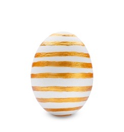 Photo of Traditional Easter egg decorated with golden paint on white background