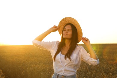 Photo of Beautiful young woman in ripe wheat field on sunny day
