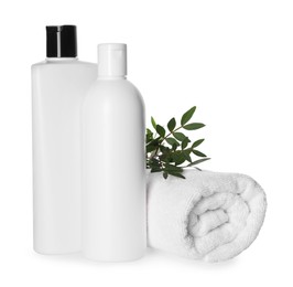 Photo of Bottles of shampoo and terry towel on white background