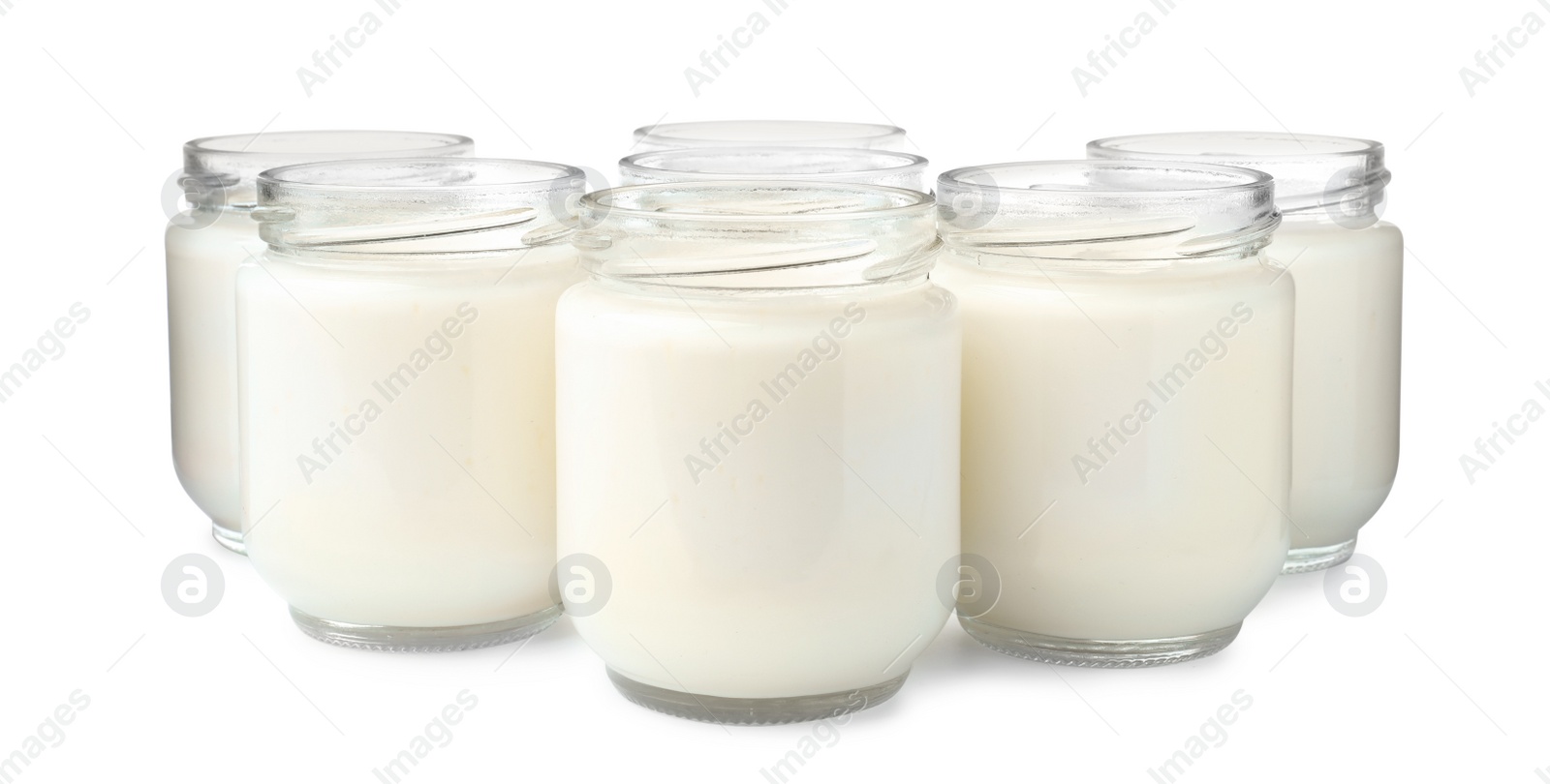 Photo of Glass jars with delicious homemade yogurt on white background