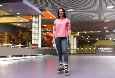 Young woman spending time at roller skating rink