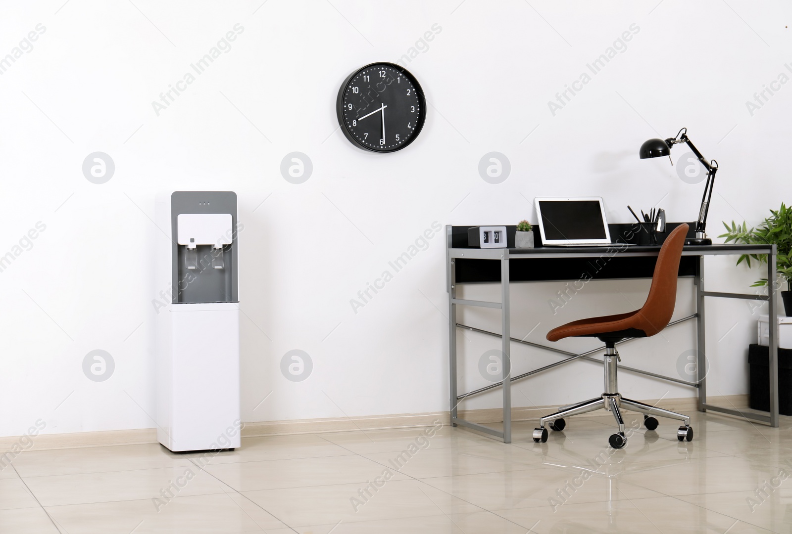 Photo of Modern water cooler in stylish office interior