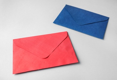 Photo of Colorful paper envelopes on light background. Mail service
