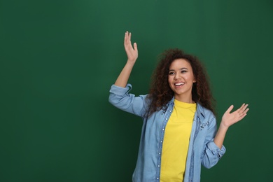 Portrait of emotional African-American woman on color background. Space for text