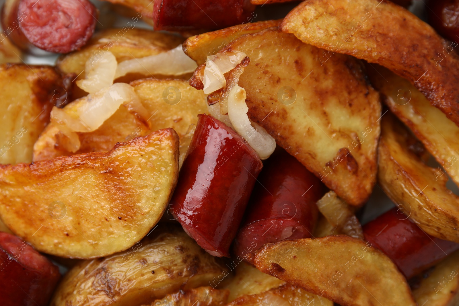 Photo of Delicious baked potato with thin dry smoked sausages and onion as background, top view