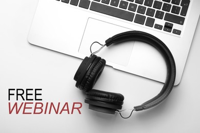Image of FREE WEBINAR. Modern headphones and laptop on white background, flat lay