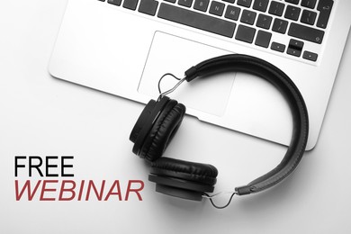 FREE WEBINAR. Modern headphones and laptop on white background, flat lay