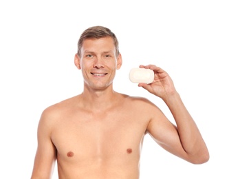 Portrait of man holding soap bar on white background