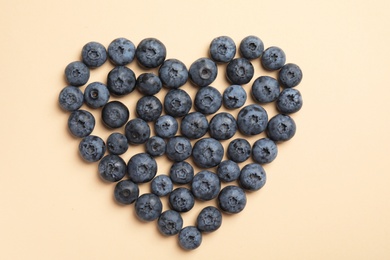 Flat lay composition with tasty blueberry on color background