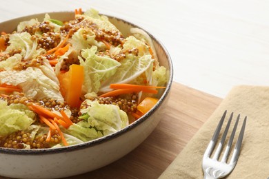 Photo of Delicious salad with Chinese cabbage and mustard seed dressing on white wooden table, closeup