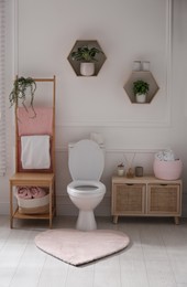 Stylish bathroom interior with toilet bowl and other essentials