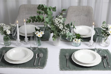 Photo of Elegant festive setting with floral decor on table