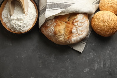 Photo of Flat lay composition with fresh bread and space for text on grey table