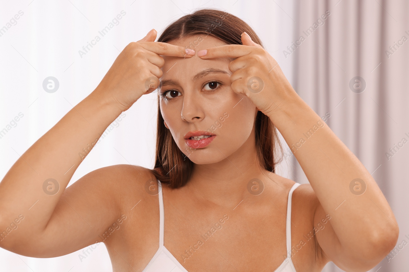 Photo of Woman with skin problem indoors, view from mirror