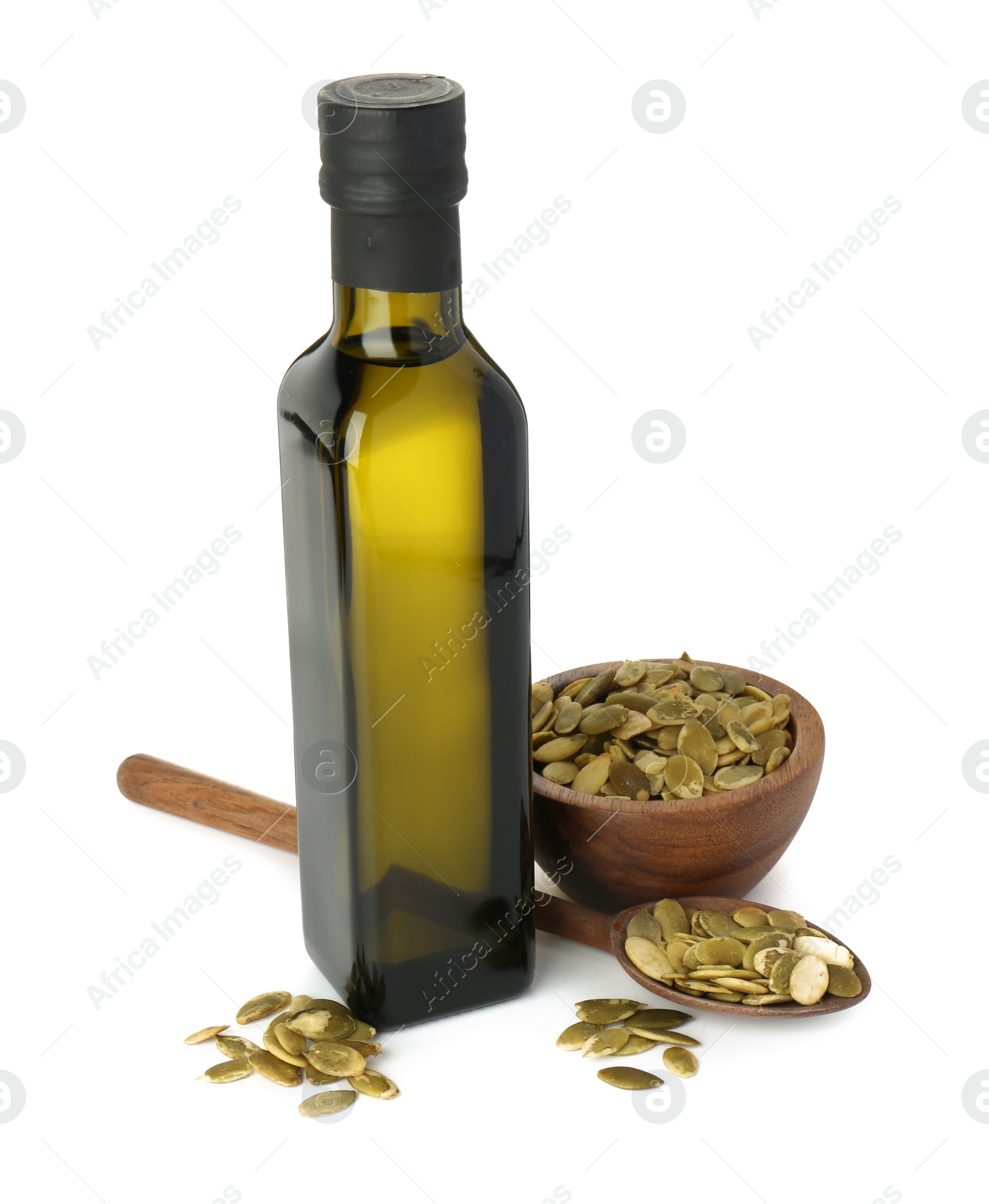 Photo of Vegetable fats. Cooking oil in glass bottle and pumpkin seeds isolated on white