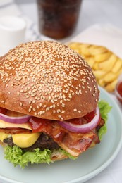 Photo of Delicious burger with bacon, patty and vegetables on table, closeup