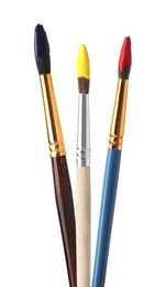 Photo of Different brushes with paints on white background