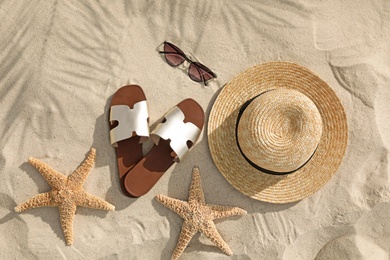 Flat lay composition with beach accessories on sand