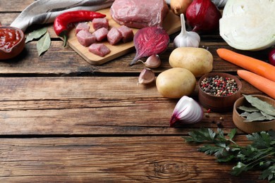 Photo of Fresh borscht ingredients on wooden table. Space for text