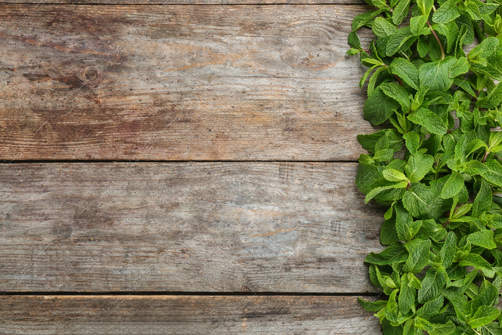 Photo of Fresh aromatic mint on wooden background, top view